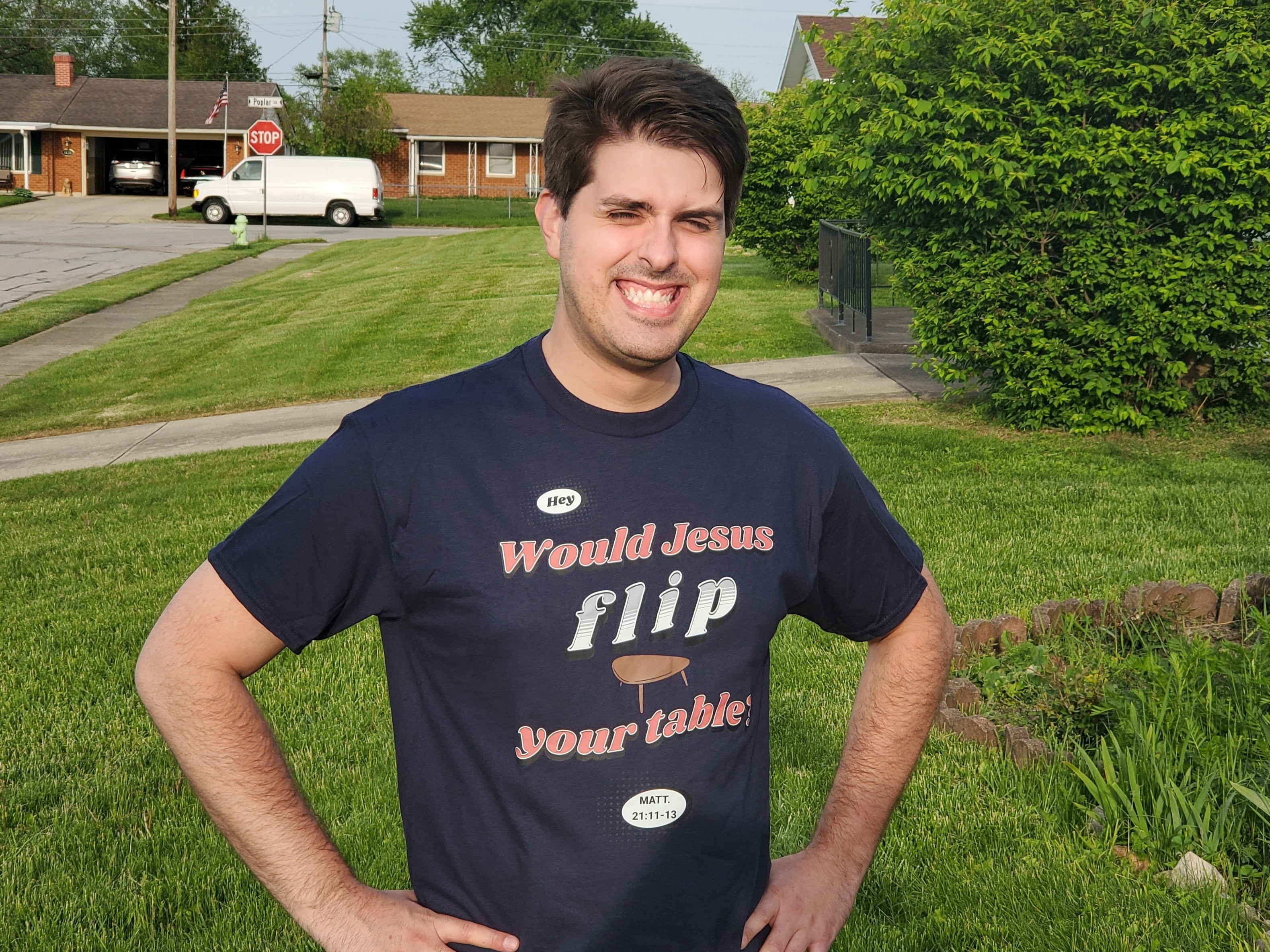 Man wearing a t-shirt with a humorous message in a suburban neighborhood